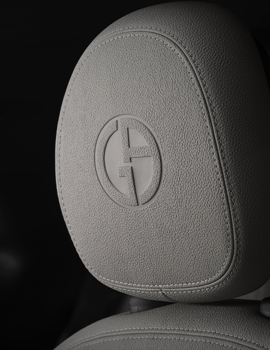 El logotipo de Giorgio Armani (GA) en el reposacabezas del asiento delantero del FIAT 500e Edición de Colección Giorgio Armani 2025.